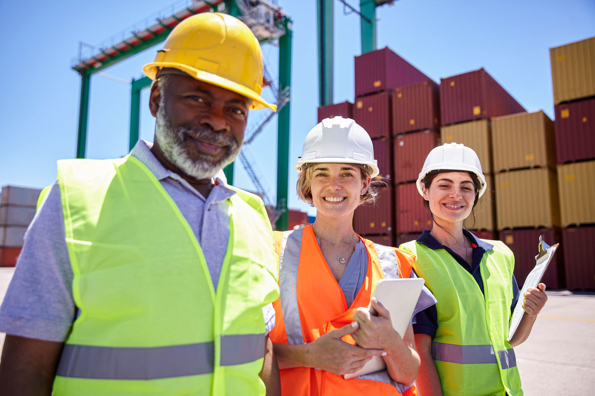 Logistics team standing in shipping yard